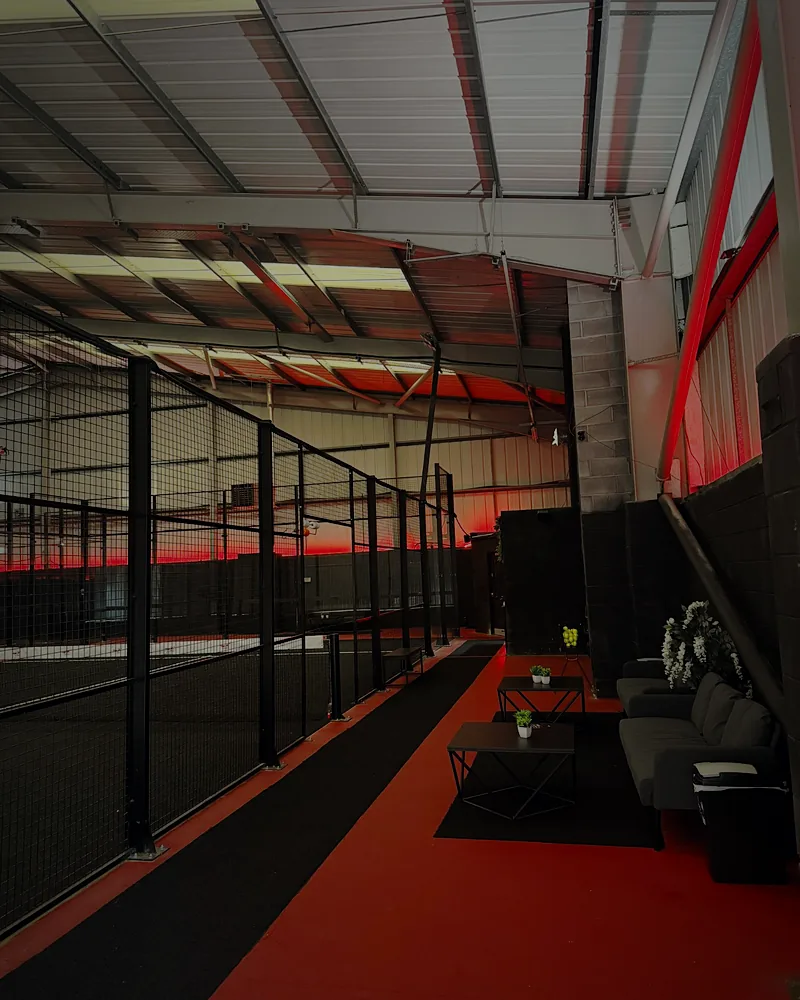 Players lounge with sofas beside the courts